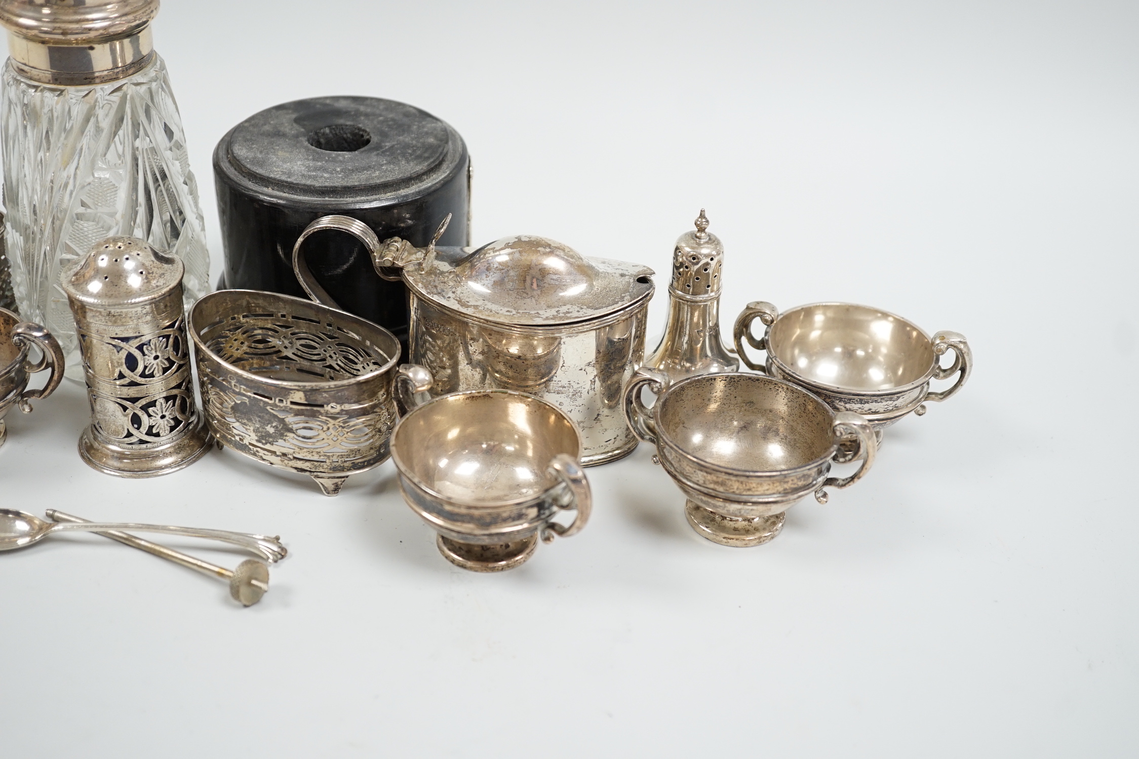 Sundry silver items including mainly condiments and a silver mounted glass caster.